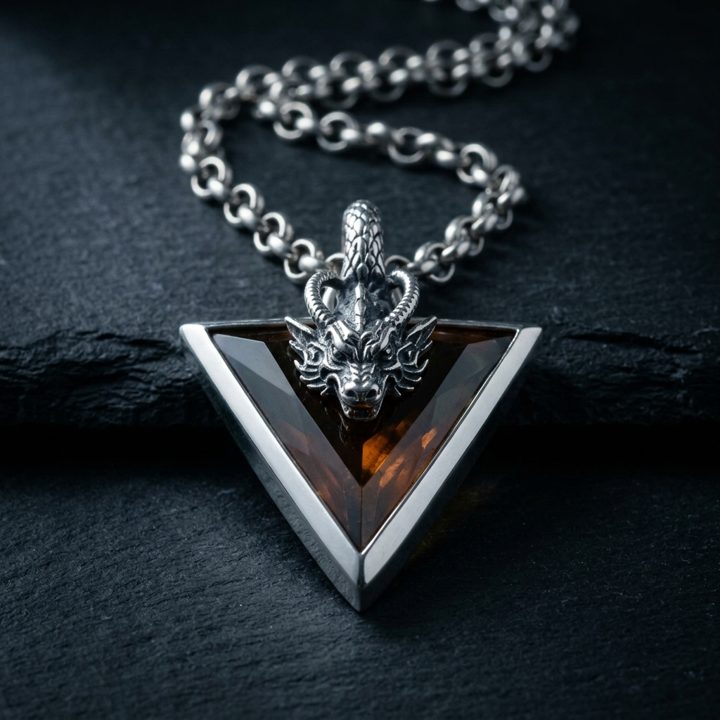 Mercurius: a sterling silver dragon pendant set with amber-cognac hydrothermal quartz on dark slate